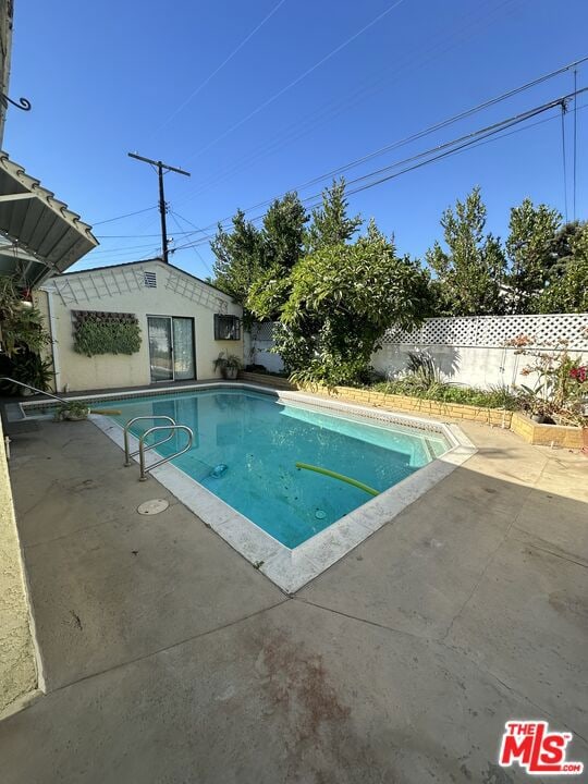 view of swimming pool with a patio area