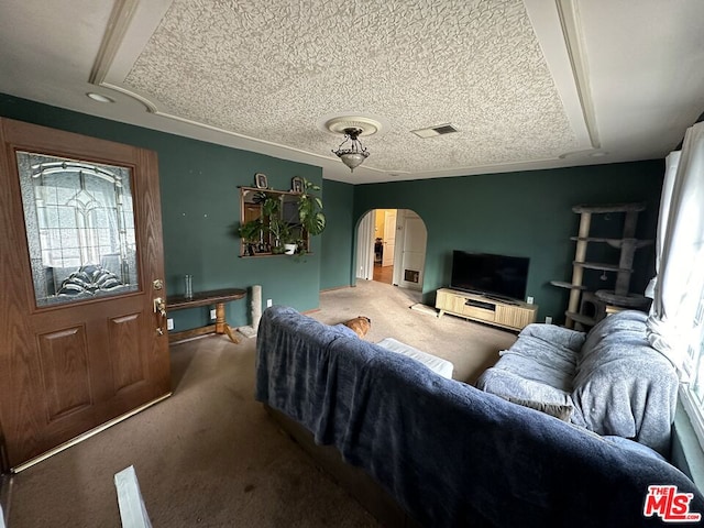 living room featuring carpet and a textured ceiling