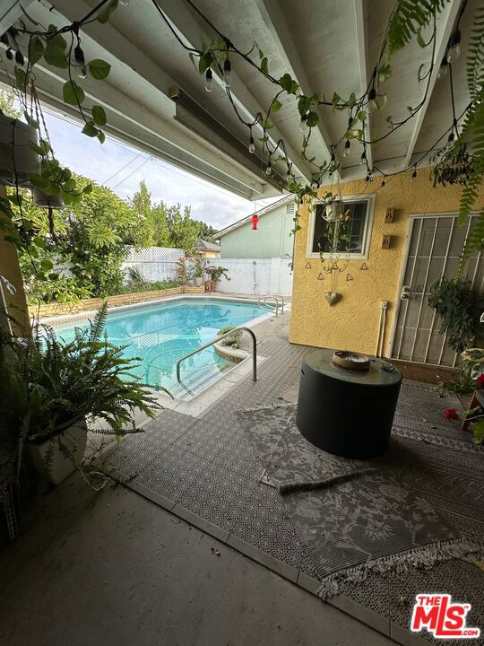 view of swimming pool featuring a patio area