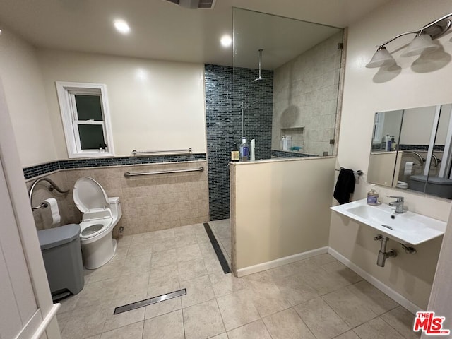 bathroom featuring a tile shower, toilet, and tile patterned floors