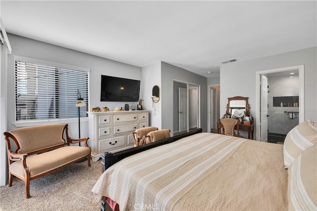 bedroom with carpet floors and ensuite bath