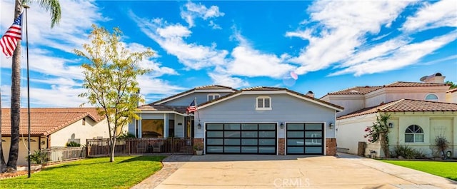 view of front of property with a front yard and a garage