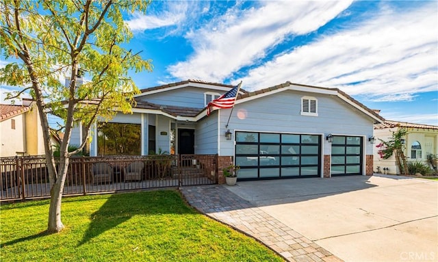 view of front of house with a front yard and a garage