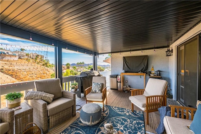 sunroom featuring wooden ceiling