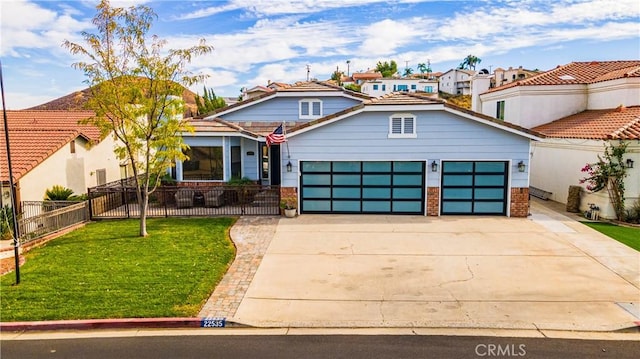 view of front of property featuring a garage and a front lawn