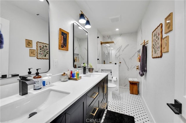 bathroom featuring tiled shower, vanity, toilet, and a fireplace