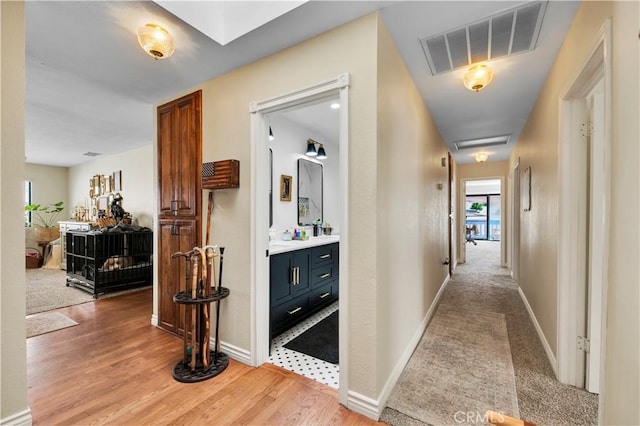 corridor with light hardwood / wood-style floors