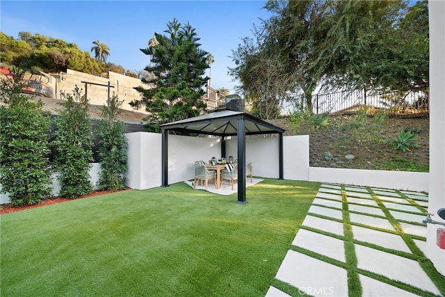 view of yard with a patio area, a fenced backyard, and a gazebo