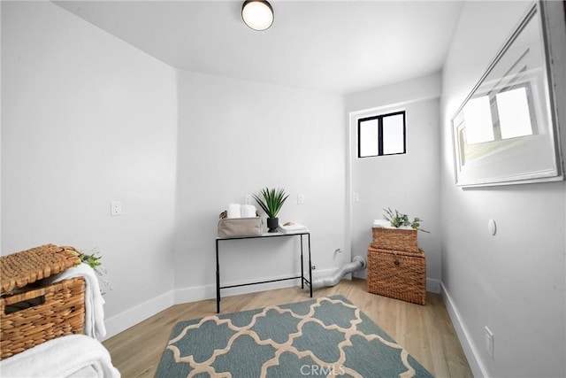 sitting room featuring baseboards and wood finished floors