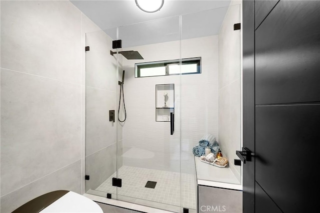 bathroom with a shower stall and toilet