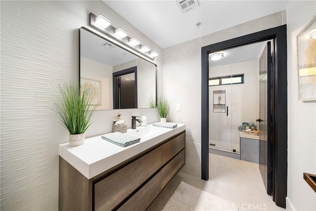 bathroom featuring a shower stall, visible vents, tile patterned flooring, and vanity