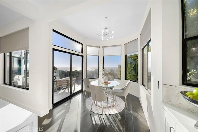 dining area with a healthy amount of sunlight, baseboards, and an inviting chandelier