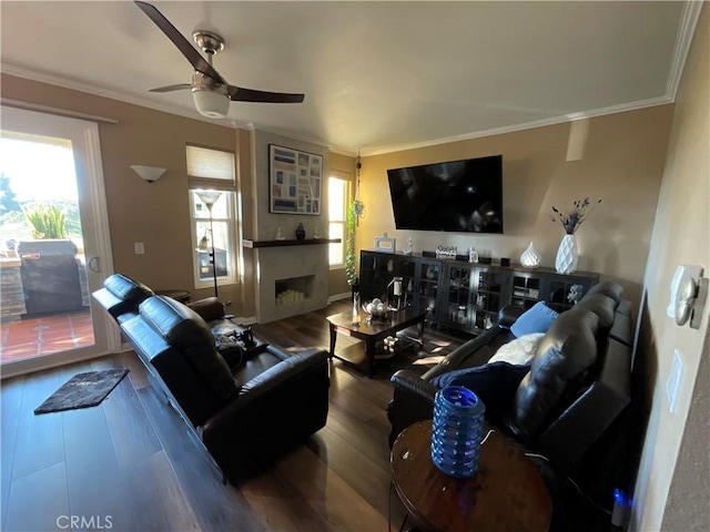 living room with ceiling fan, wood-type flooring, and ornamental molding