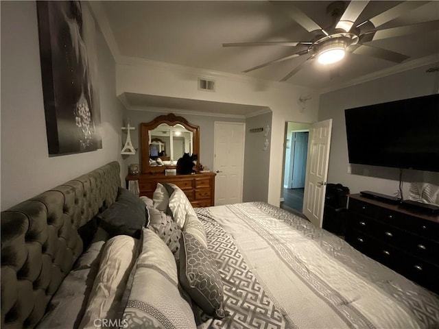 bedroom with ceiling fan and ornamental molding