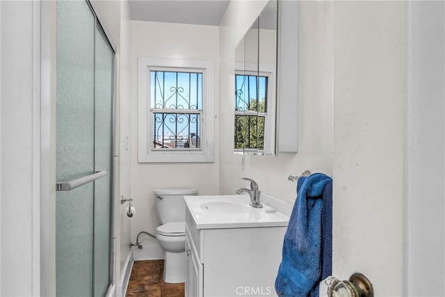 full bath featuring vanity, a shower stall, and toilet