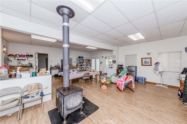 11507 Savage Ln, Apple Valley, CA 92308 - misc room featuring a drop ceiling, a wood stove, and wood finished floors