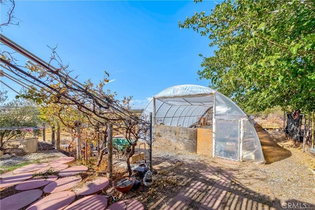11507 Savage Ln, Apple Valley, CA 92308 - wooden terrace with a greenhouse and an outbuilding