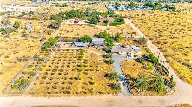 birds eye view of property with a rural view