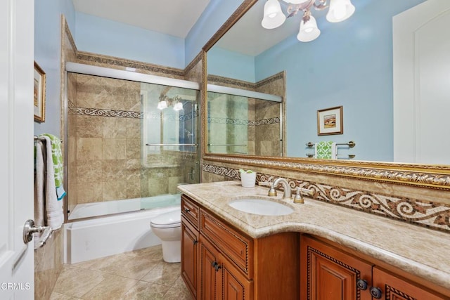 full bathroom with tile patterned flooring, vanity, toilet, and bath / shower combo with glass door