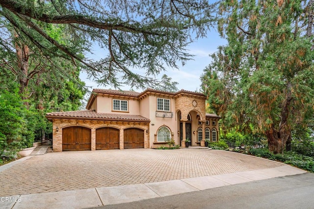 mediterranean / spanish-style home with a garage