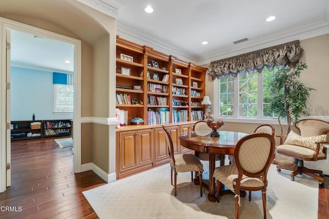 living area with dark hardwood / wood-style floors and ornamental molding