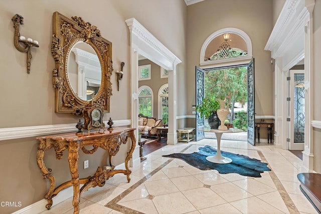 foyer featuring light tile patterned floors and a high ceiling