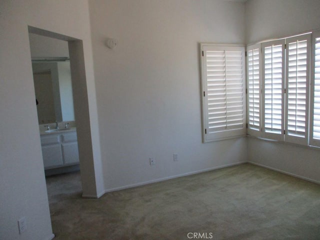 empty room with sink and carpet floors