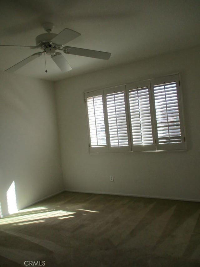 carpeted empty room with plenty of natural light and ceiling fan