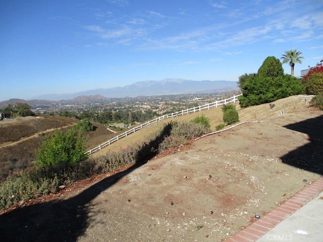 view of yard with a mountain view and a rural view