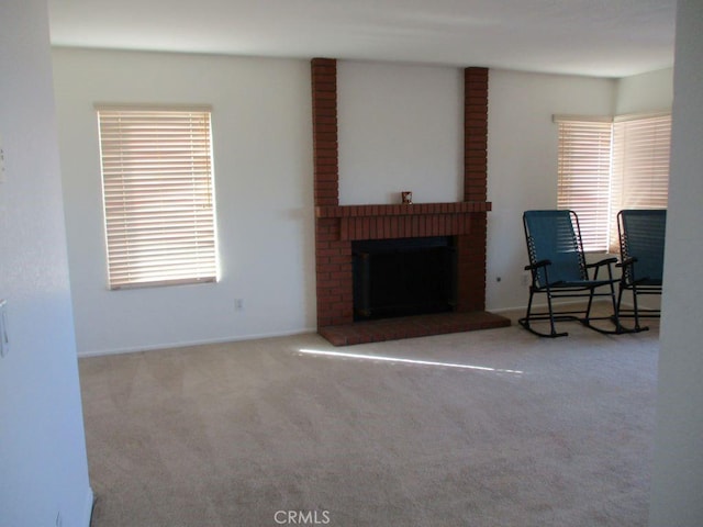 carpeted living room featuring a fireplace