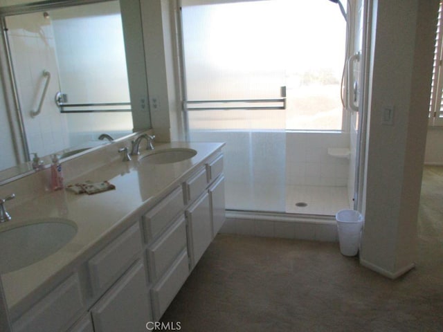 bathroom featuring vanity and a shower with shower door