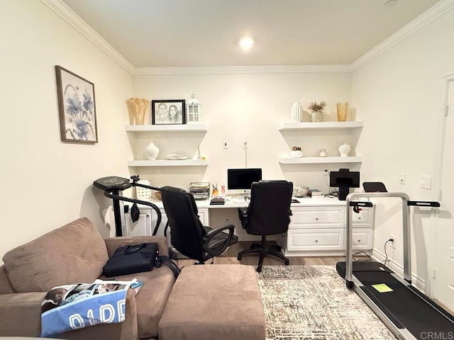 office featuring built in desk, crown molding, and hardwood / wood-style flooring