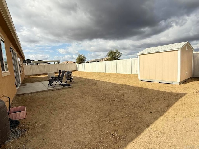 view of yard with a patio and a shed