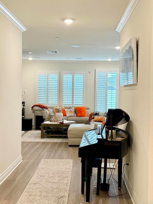 living room featuring crown molding and light wood-type flooring