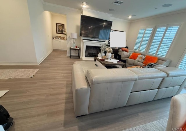 living room featuring light hardwood / wood-style flooring and ornamental molding