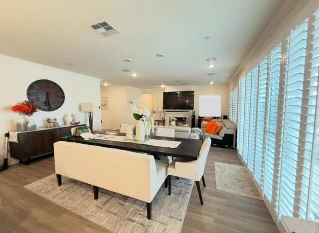 dining space featuring ornamental molding and wood-type flooring