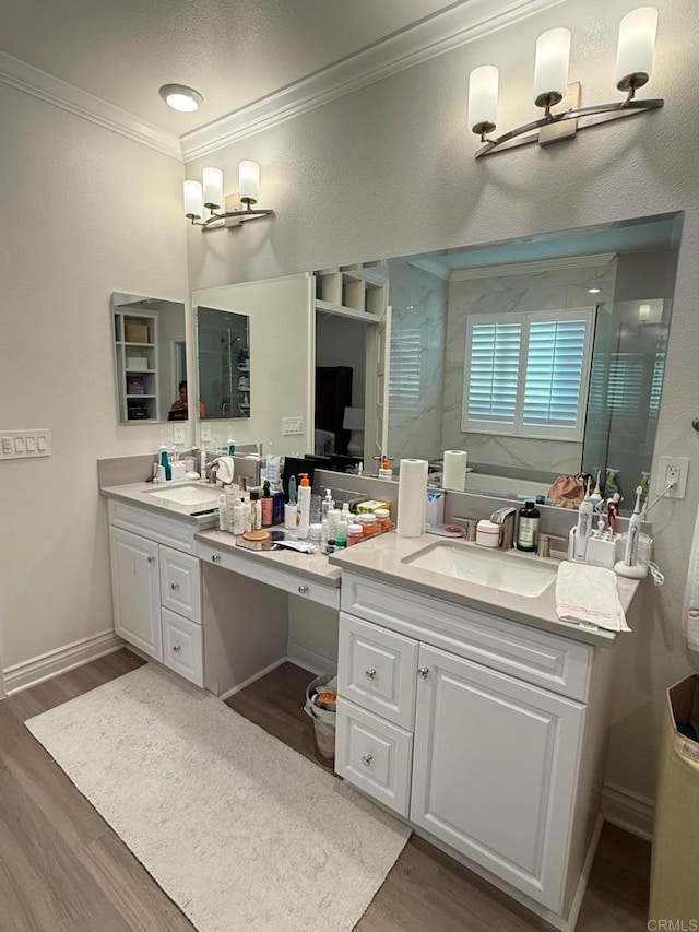 bathroom featuring vanity, ornamental molding, hardwood / wood-style flooring, and a shower