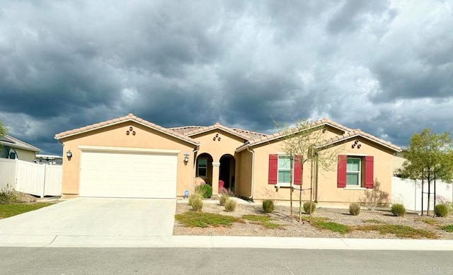 mediterranean / spanish-style home with a garage