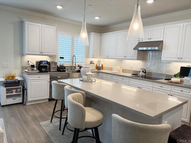 kitchen featuring black electric stovetop, white cabinets, dishwasher, and a center island