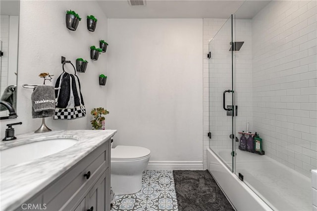 full bathroom featuring combined bath / shower with glass door, vanity, toilet, and tile patterned flooring