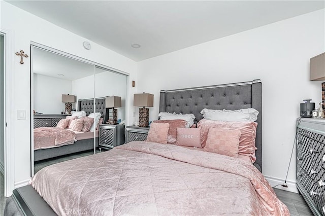 bedroom with a closet and hardwood / wood-style floors