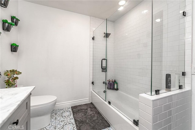 full bathroom with tile patterned floors, vanity, toilet, and enclosed tub / shower combo