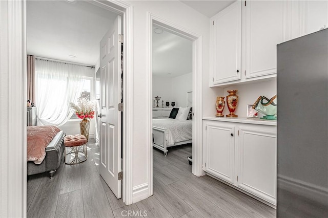 hallway with light hardwood / wood-style flooring