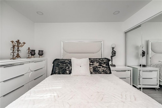 bedroom featuring dark hardwood / wood-style flooring and a closet