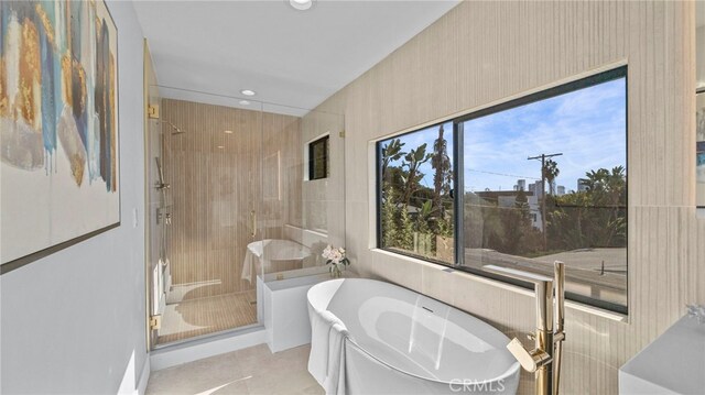 bathroom with separate shower and tub