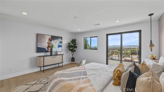 bedroom featuring access to exterior and light hardwood / wood-style floors