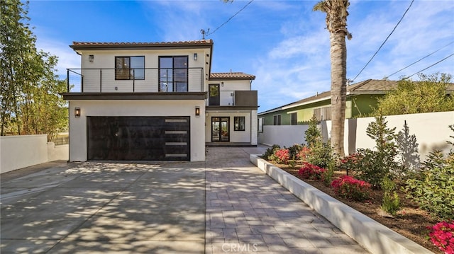 mediterranean / spanish home featuring a balcony and a garage