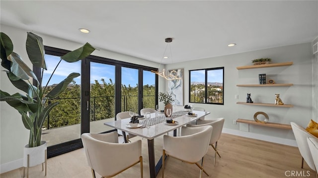 dining room with a chandelier and light hardwood / wood-style floors