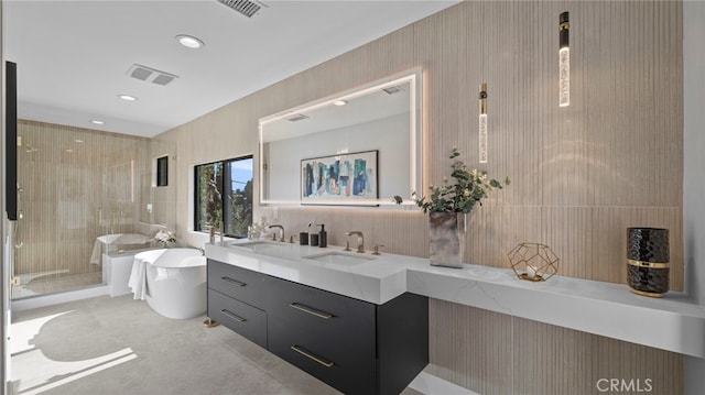 bathroom featuring vanity, separate shower and tub, and tile walls