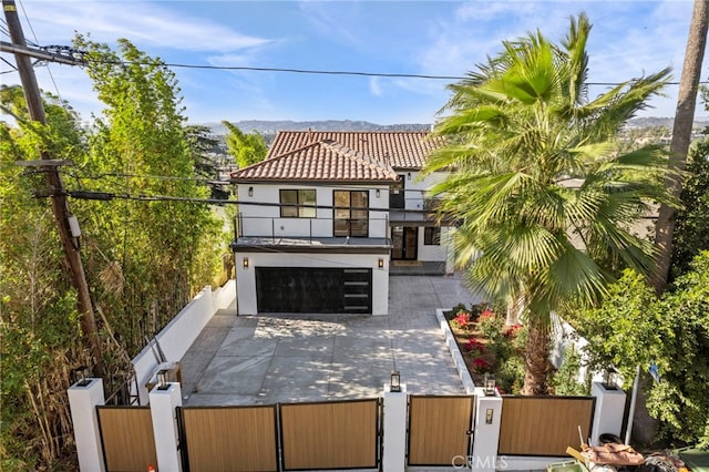 exterior space featuring a balcony and a garage